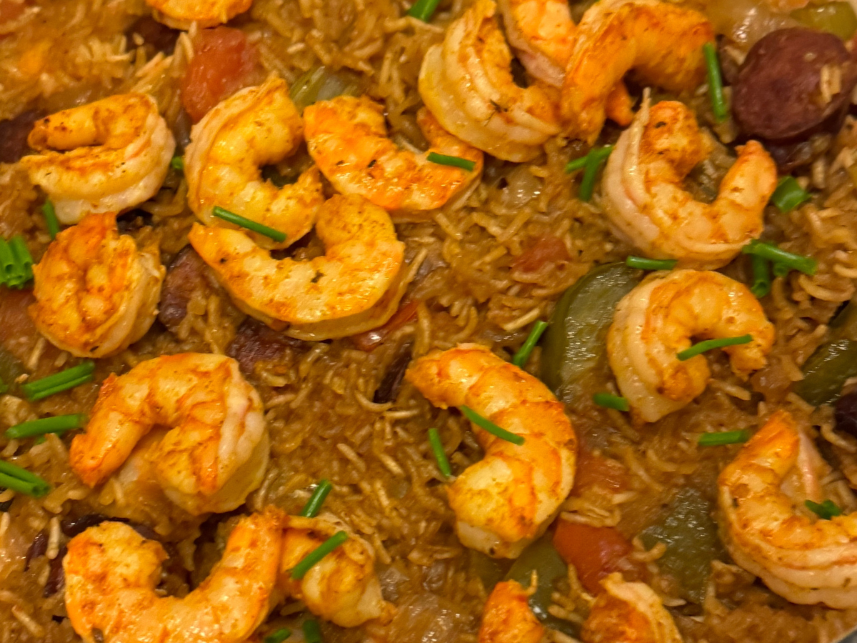 A dutch oven of jambalaya with shrimp and andouille sausage